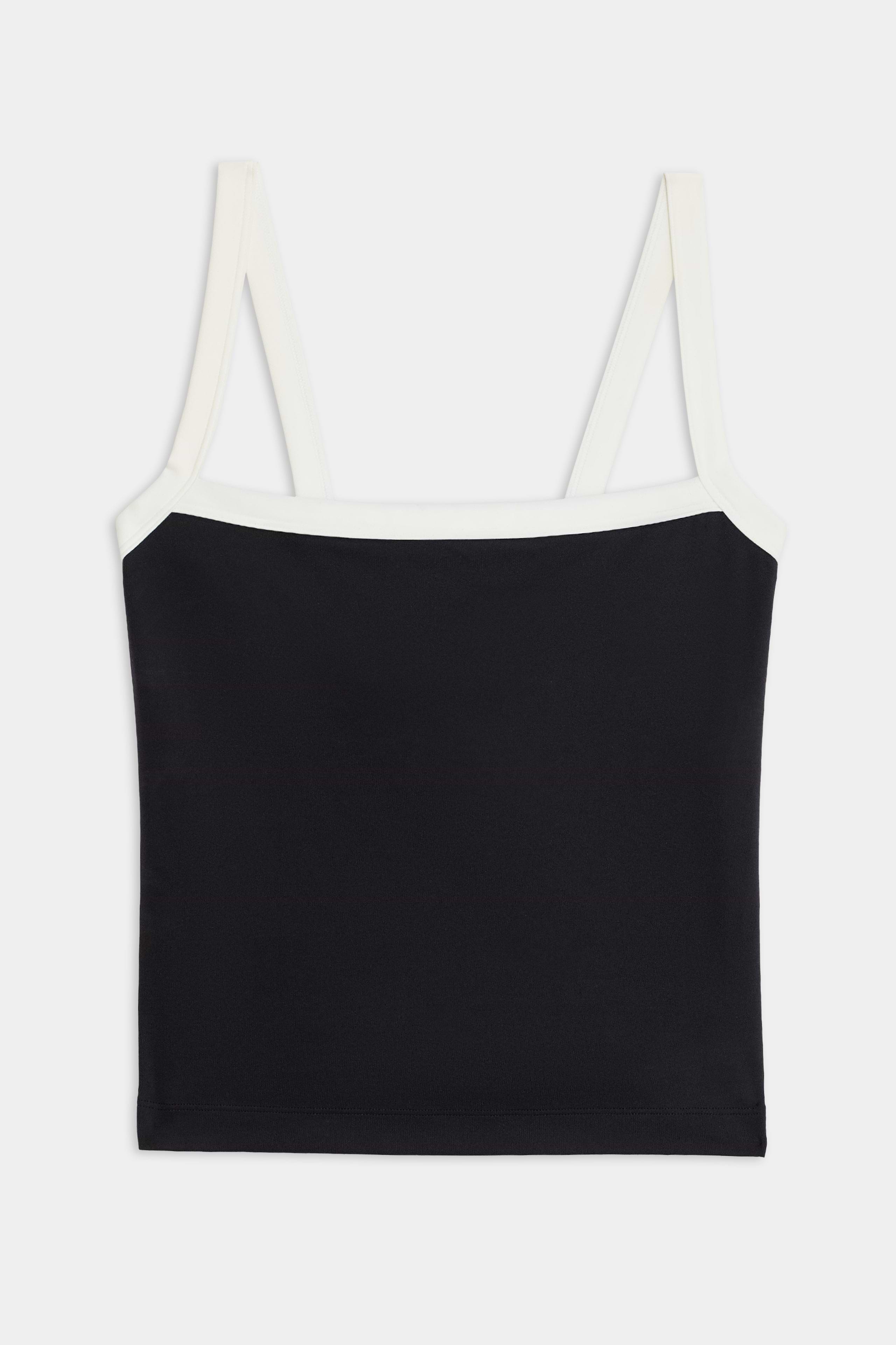 The SPLITS59 Monah Rigor Tank - Black/White is a black sleeveless crop top with white straps and neckline trim, made from durable Rigor fabric—ideal for gym workouts. Shown on a plain white background.