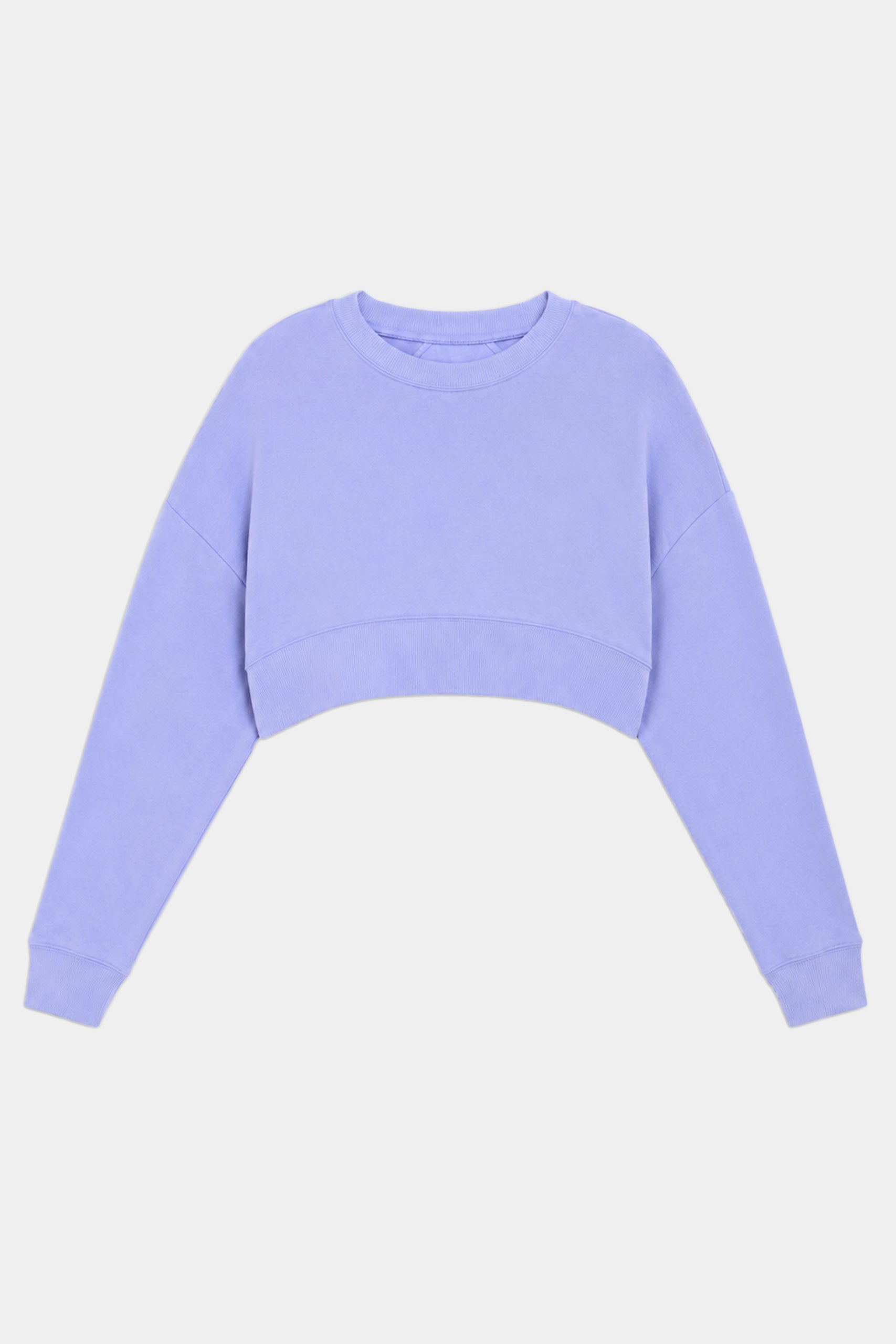 The SPLITS59 Noah Fleece Crop Sweatshirt in Purple Haze is a long-sleeve, crew neck, lavender cropped top made from a stretchy spandex blend, shown against a plain white background.