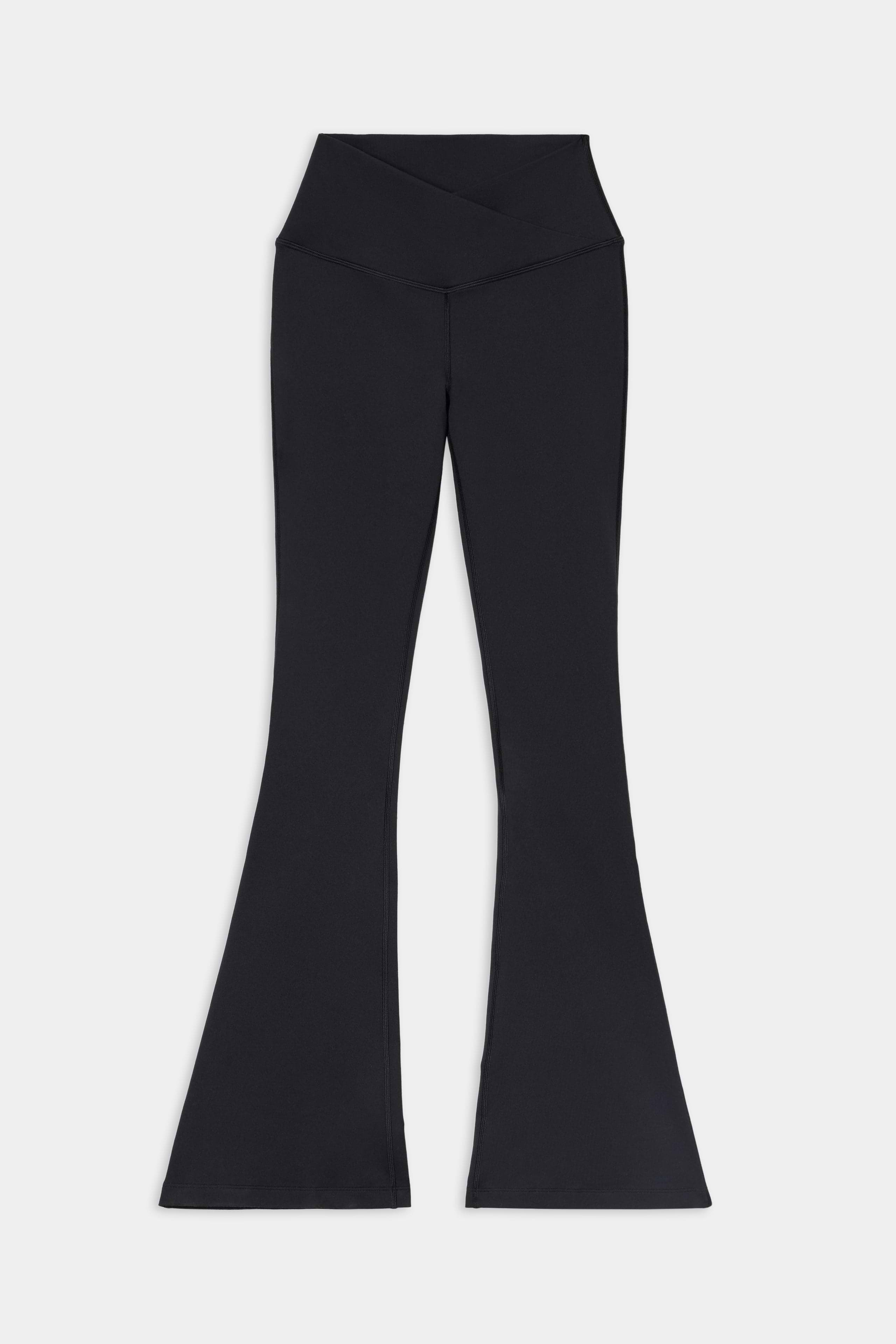 Raquel Crossover Supplex Flare - Black by SPLITS59, high-waisted flared leggings made from a soft nylon-spandex blend with a crossover waistband, displayed laid flat on a white background.