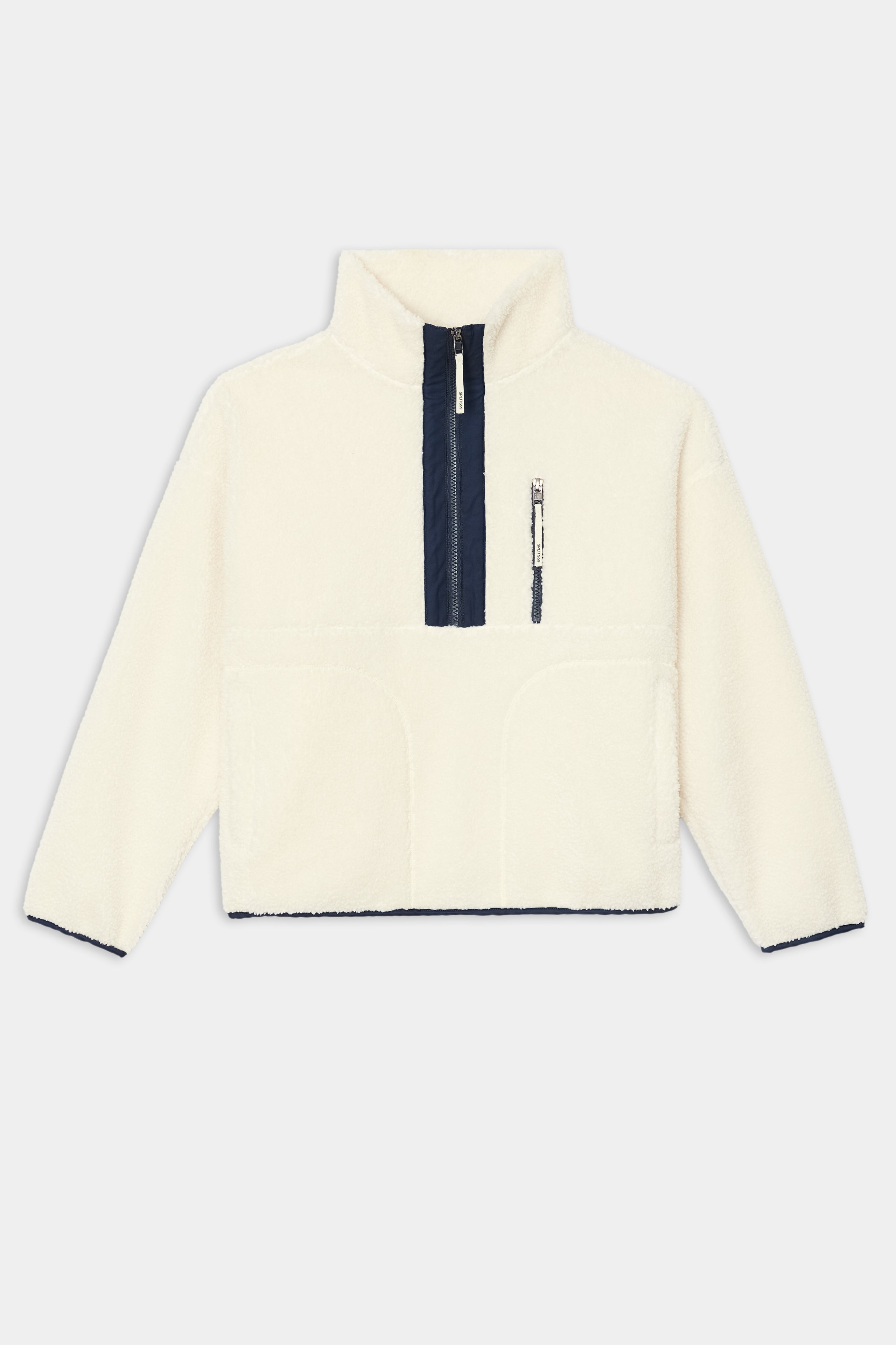 The SPLITS59 Reese Sherpa Half Zip Pullover in Creme/Indigo features a high collar, front half-zip closure, dark indigo trim, and a zippered chest pocket. Crafted from soft 100% polyester for warmth and durability.