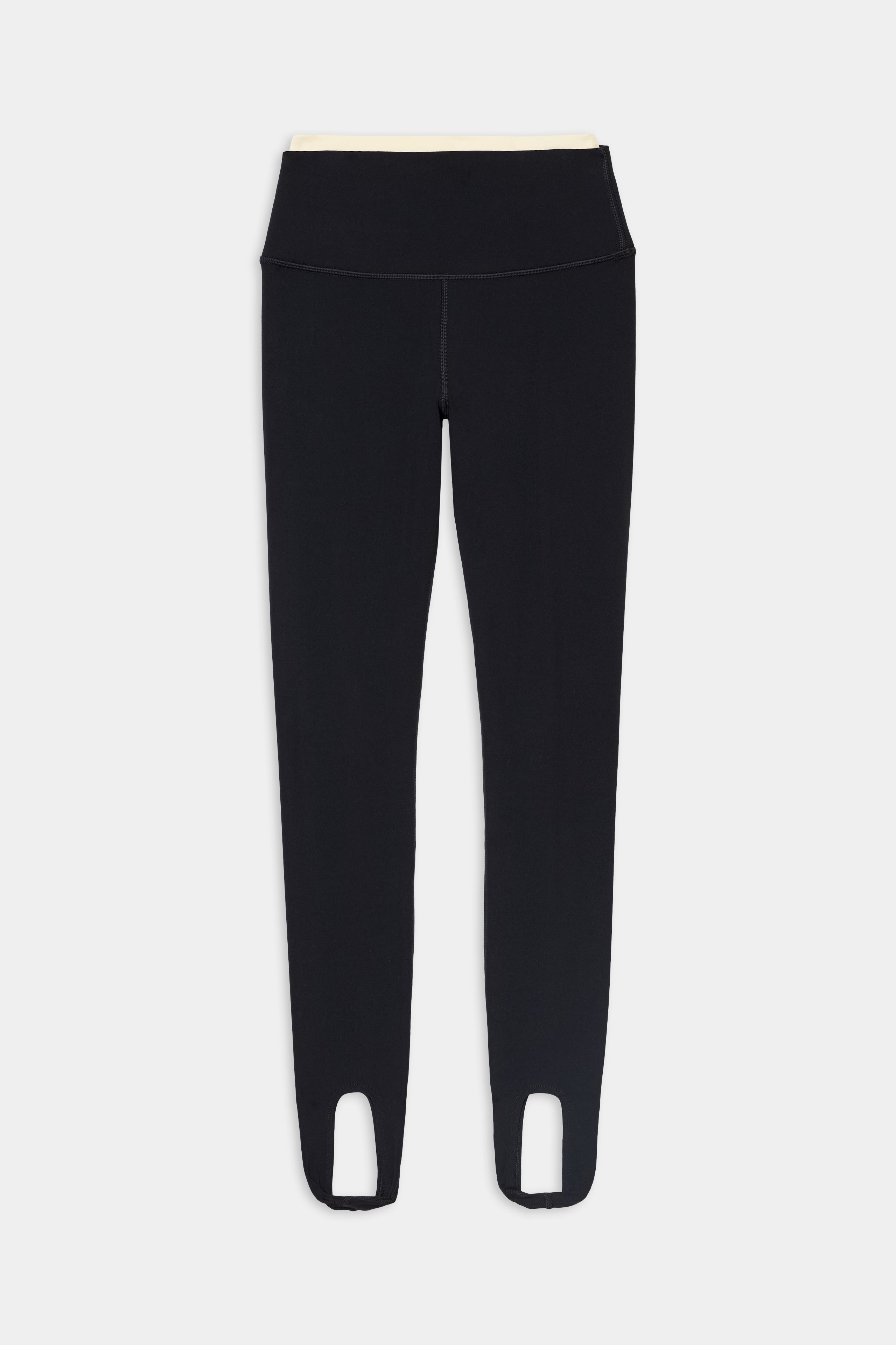 The SPLITS59 River Dual Waist Airweight Stirrup in Black/Creme features high-waisted, stretch leggings with stirrups at the ankle, displayed flat against a white background.