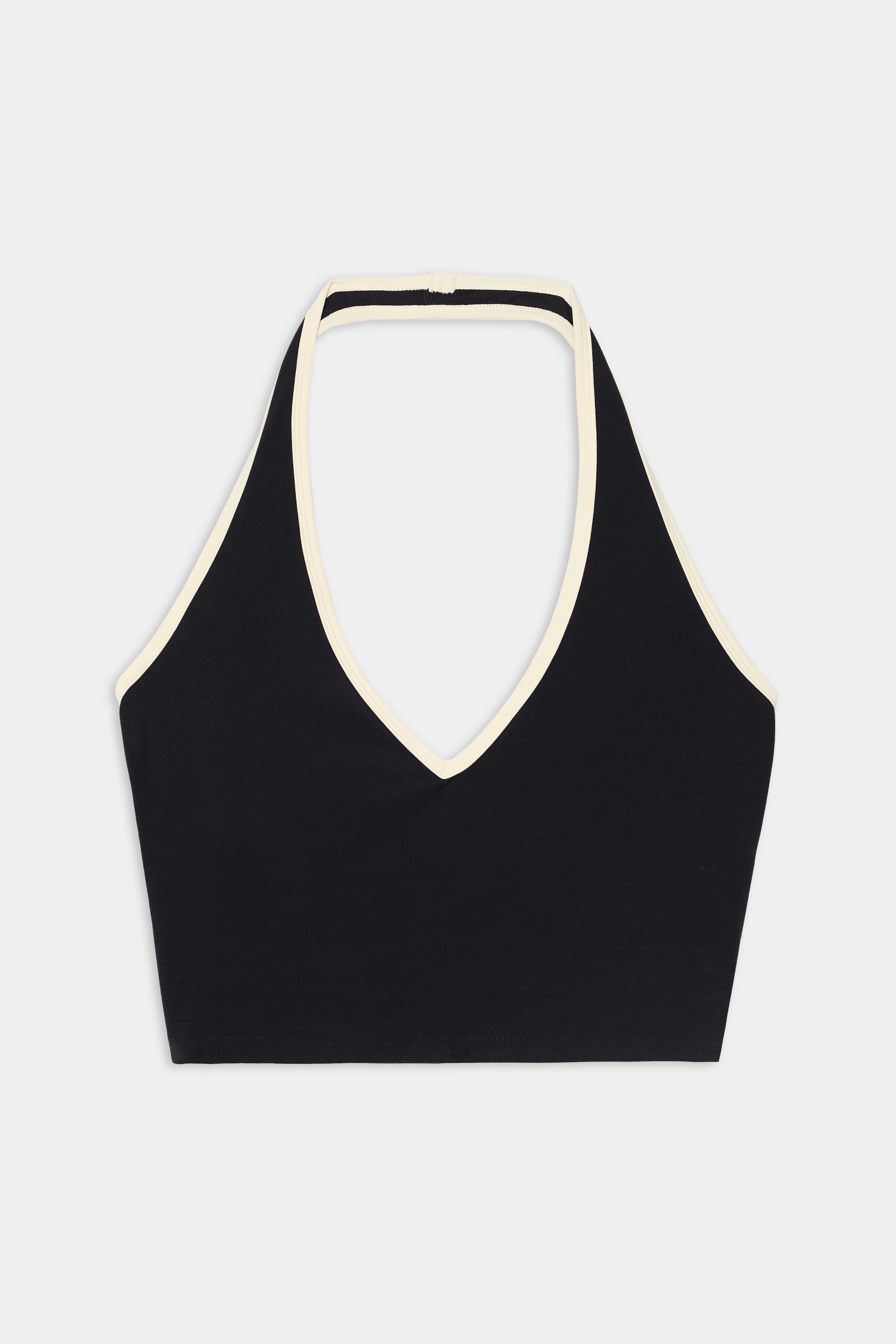 The SPLITS59 Rory Airweight Halter Bralette in Black/Creme features a black design with cream-colored trim along the neckline and straps, crafted to pair seamlessly with your favorite nylon leggings. Shown against a plain white background.