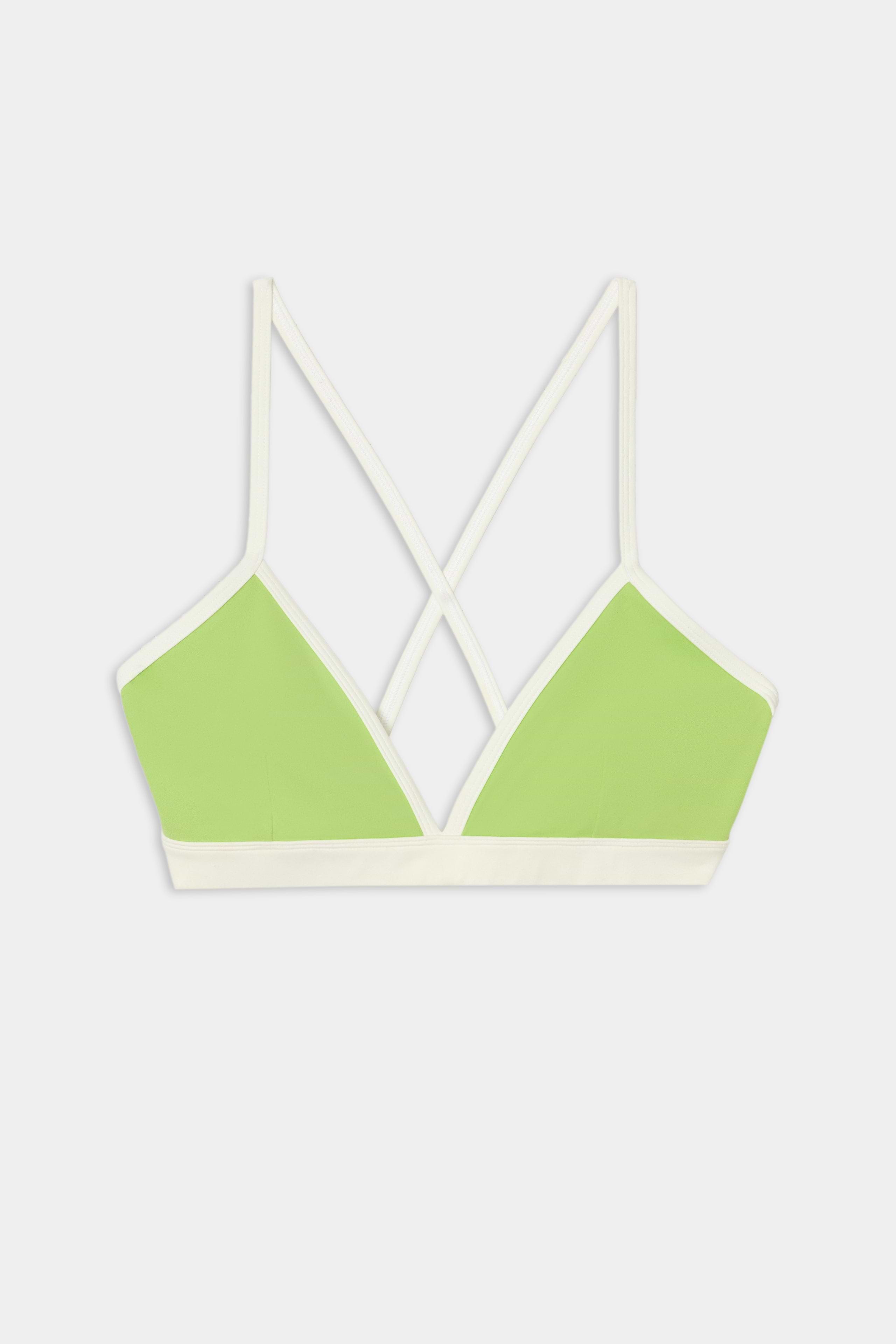 The SPLITS59 Sage Rigor Bra in Limeade/White features a light green design with white trim, thin crisscross back straps, and is crafted from a soft nylon-spandex blend. It is showcased on a plain white background.