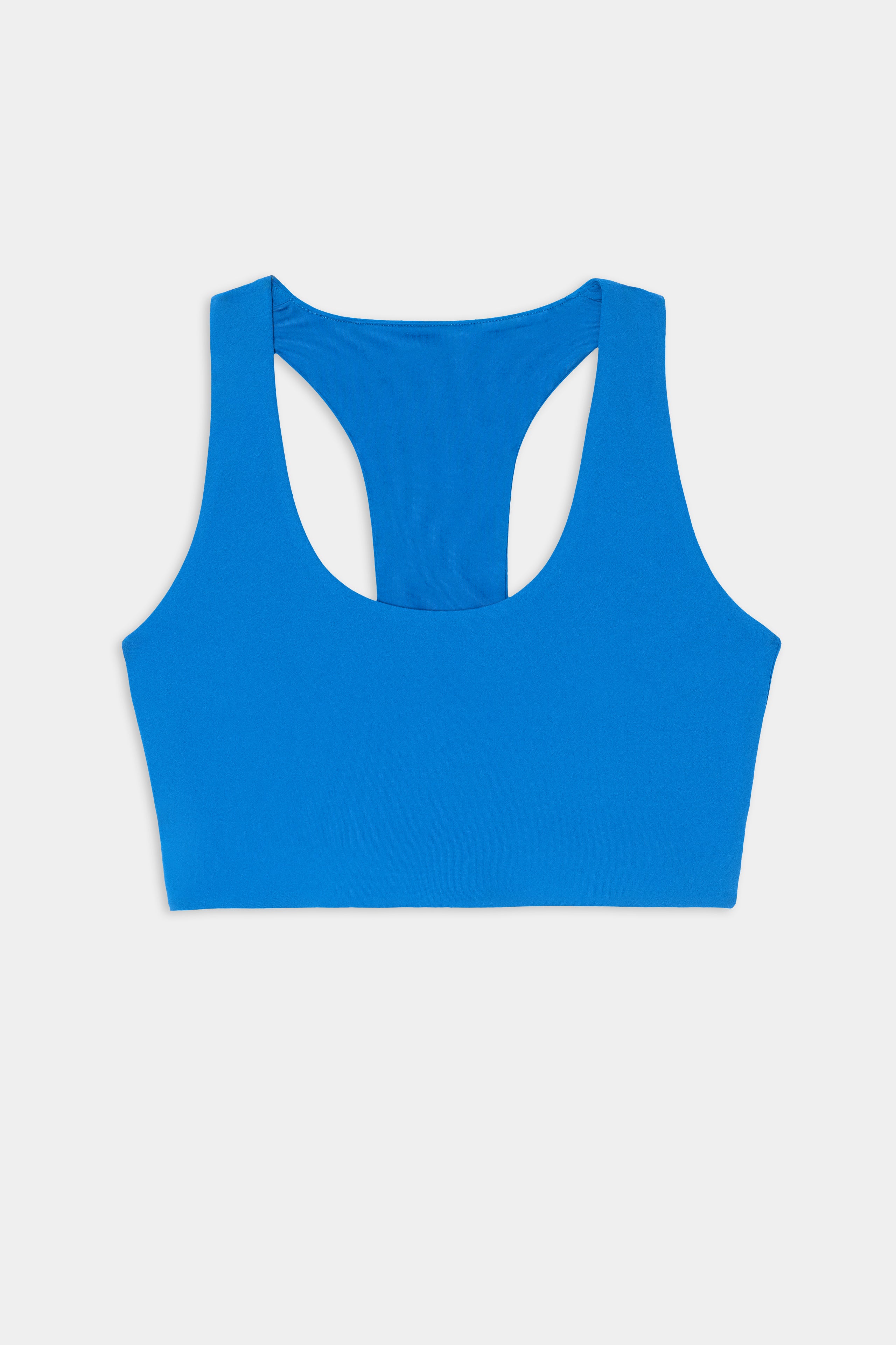 The SPLITS59 Sara Airweight Bra in Classic Blue, featuring a sleeveless racerback design ideal for hot yoga or Pilates, is displayed flat on a white background.