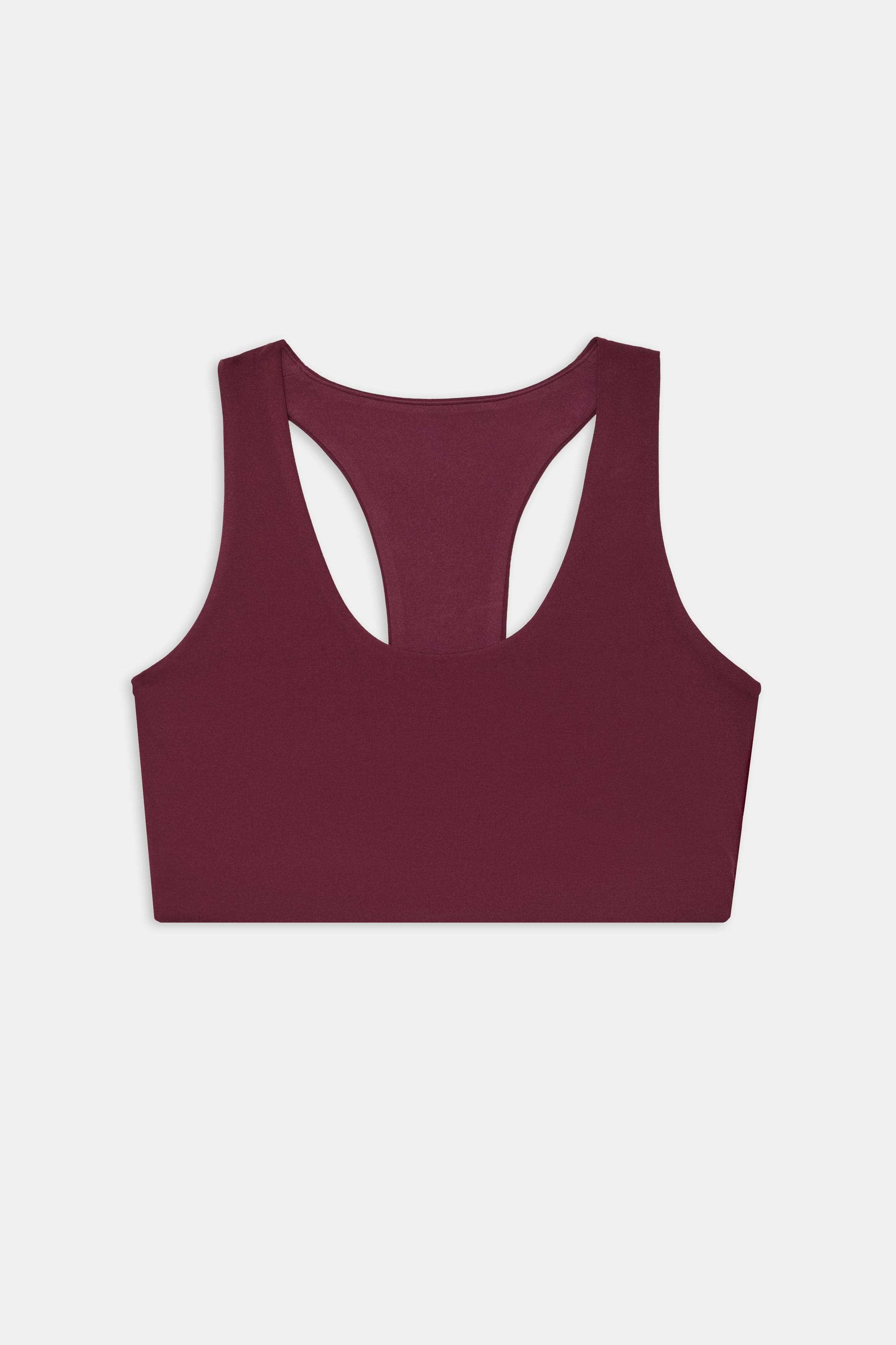 The SPLITS59 Sara Airweight Bra in Dark Cherry features a racerback design and is crafted from a soft nylon-spandex blend, shown against a plain white background.