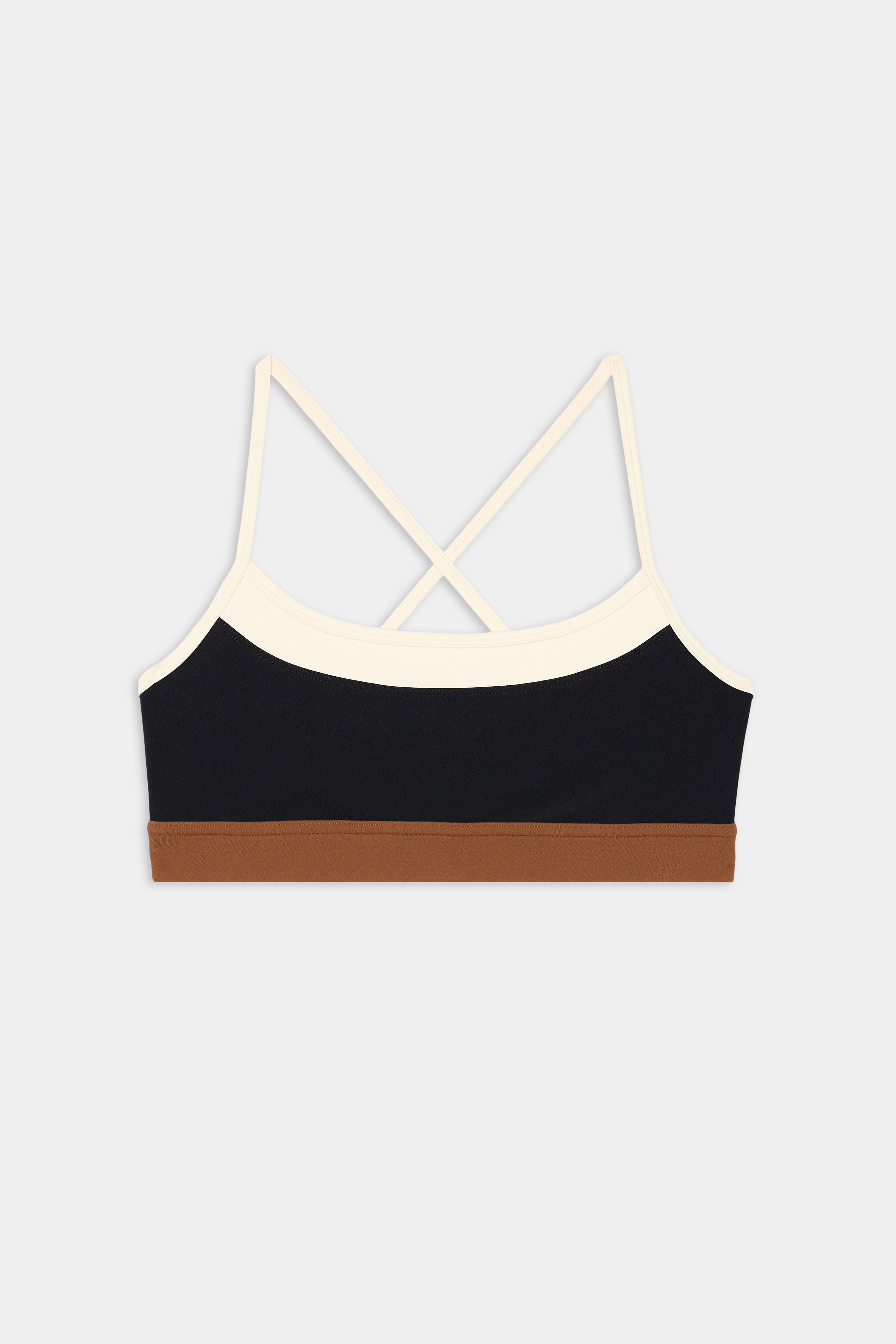 The SPLITS59 Scottie Airweight Bra - Black/Creme features cream cross-back straps, a black front panel, and a brown elastic band in stretchy spandex.