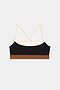 The SPLITS59 Scottie Airweight Bra - Black/Creme features cream cross-back straps, a black front panel, and a brown elastic band in stretchy spandex.