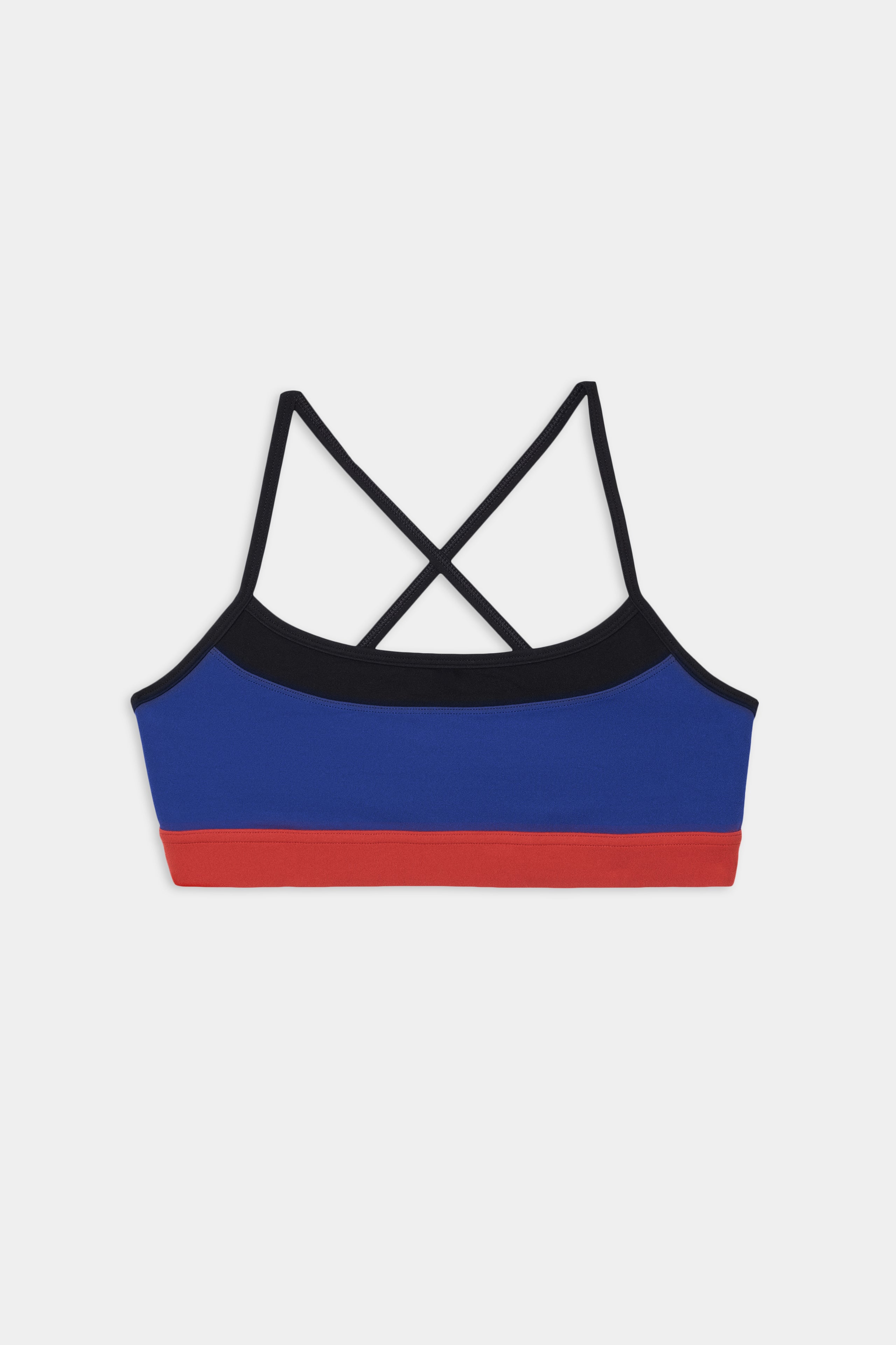 Scottie Airweight Bra - Cobalt/Indigo by SPLITS59 features black crisscross straps and a red band, made from a nylon-spandex blend, shown on a white background.