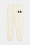 The Serena French Terry Oversized Sweatpant by SPLITS59 in Creme/59 is crafted from soft 100% cotton, featuring an elastic waistband, drawstring, cuffed ankles, and a black and white “59” detail on the left thigh.