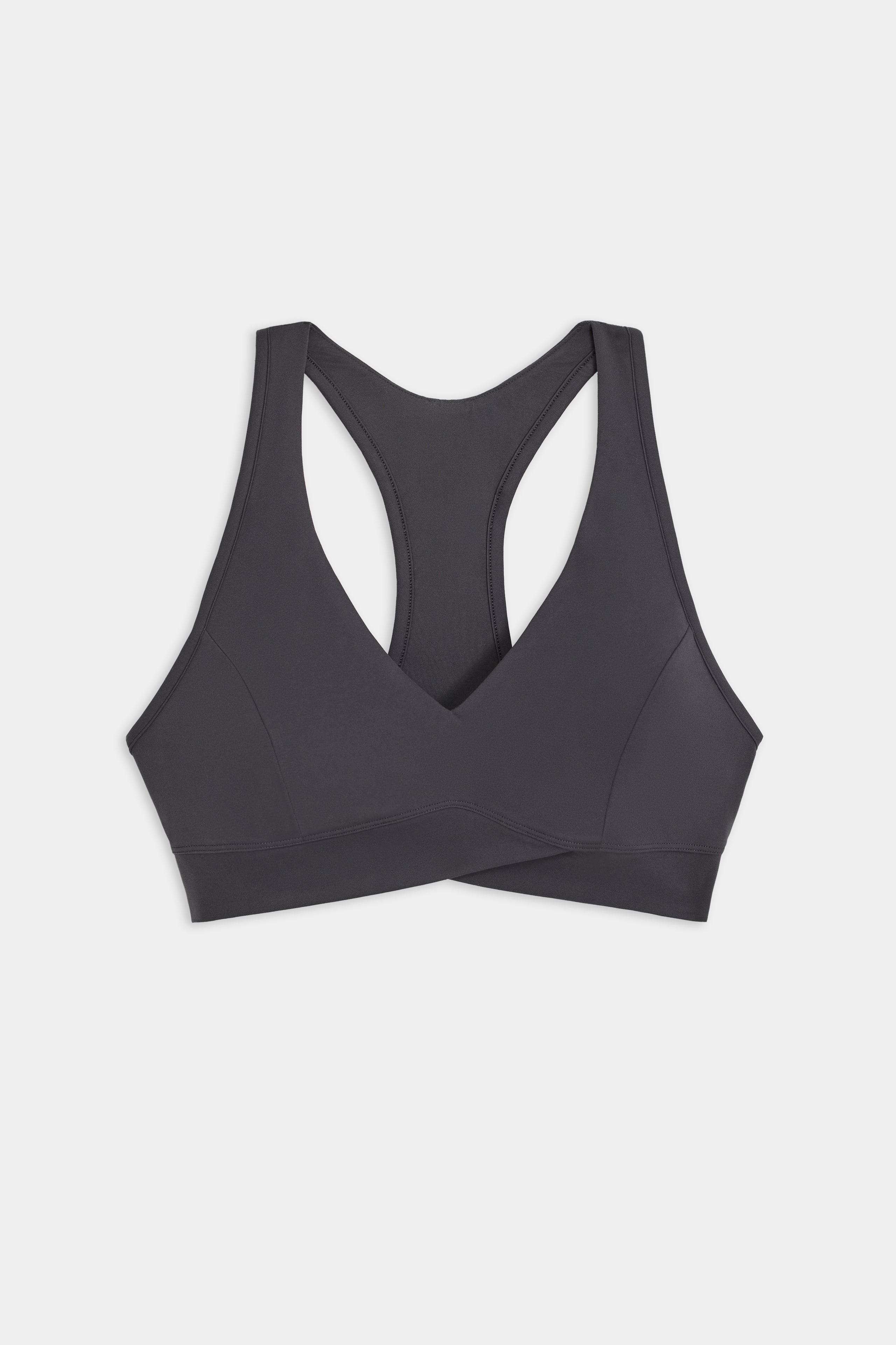 The SPLITS59 Mia Rigor Bra in Graphite—a black racerback sports bra featuring a V-neckline and wide straps, designed for multi-sport performance—is laid flat on a white background.