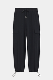 The Nico Airweight Cargo Pant by SPLITS59, in black, features a relaxed fit with side pockets and elastic cuffs. Made of lightweight Airweight fabric, these pants offer ultimate comfort and style for everyday wear, displayed flat on a white background.