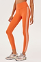 Side view of girl wearing orange leggings with two thin white stripes down the side with white shoes 