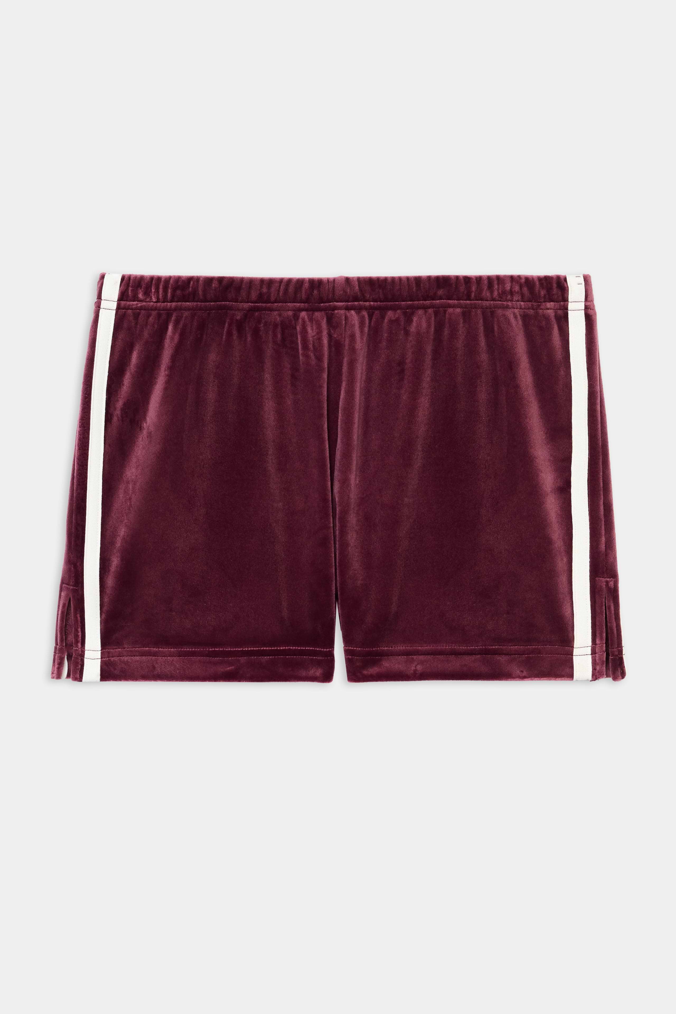 The SPLITS59 Heritage Velour Short in Dark Cherry/White features soft polyester-spandex fabric, white side stripes, and an elastic waistband, shown on a plain white background.