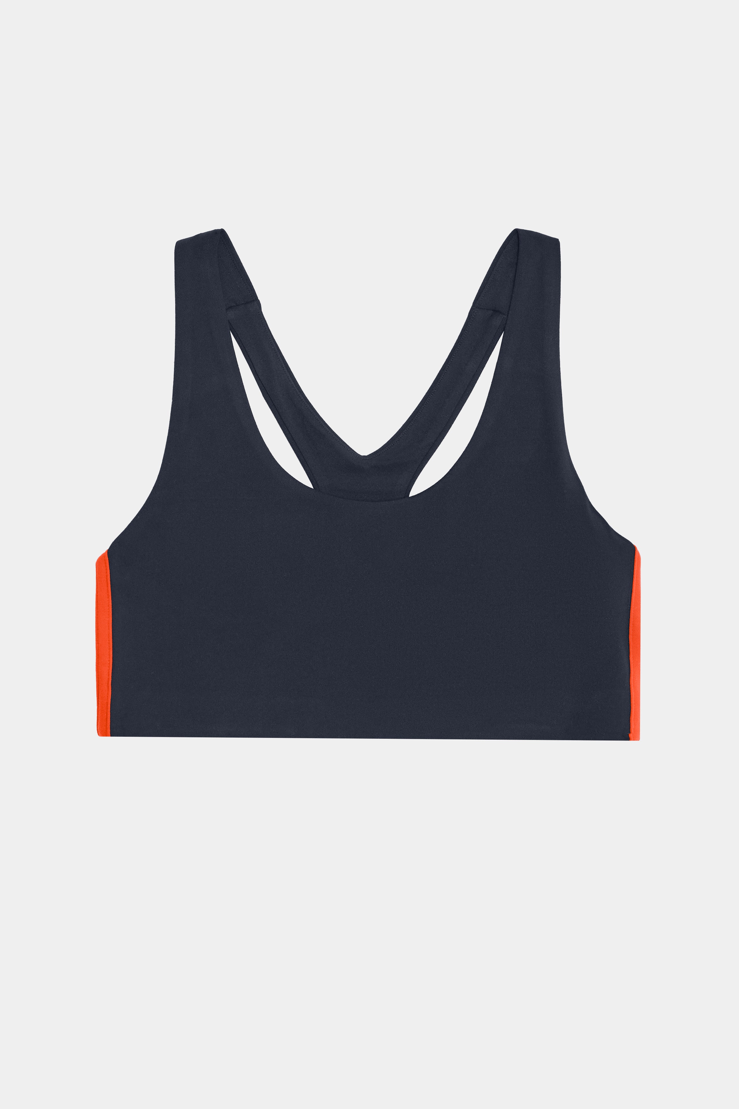 SPLITS59 Ella Airweight Bra in indigo dark navy with a racerback design, stretch material, and orange side stripes.