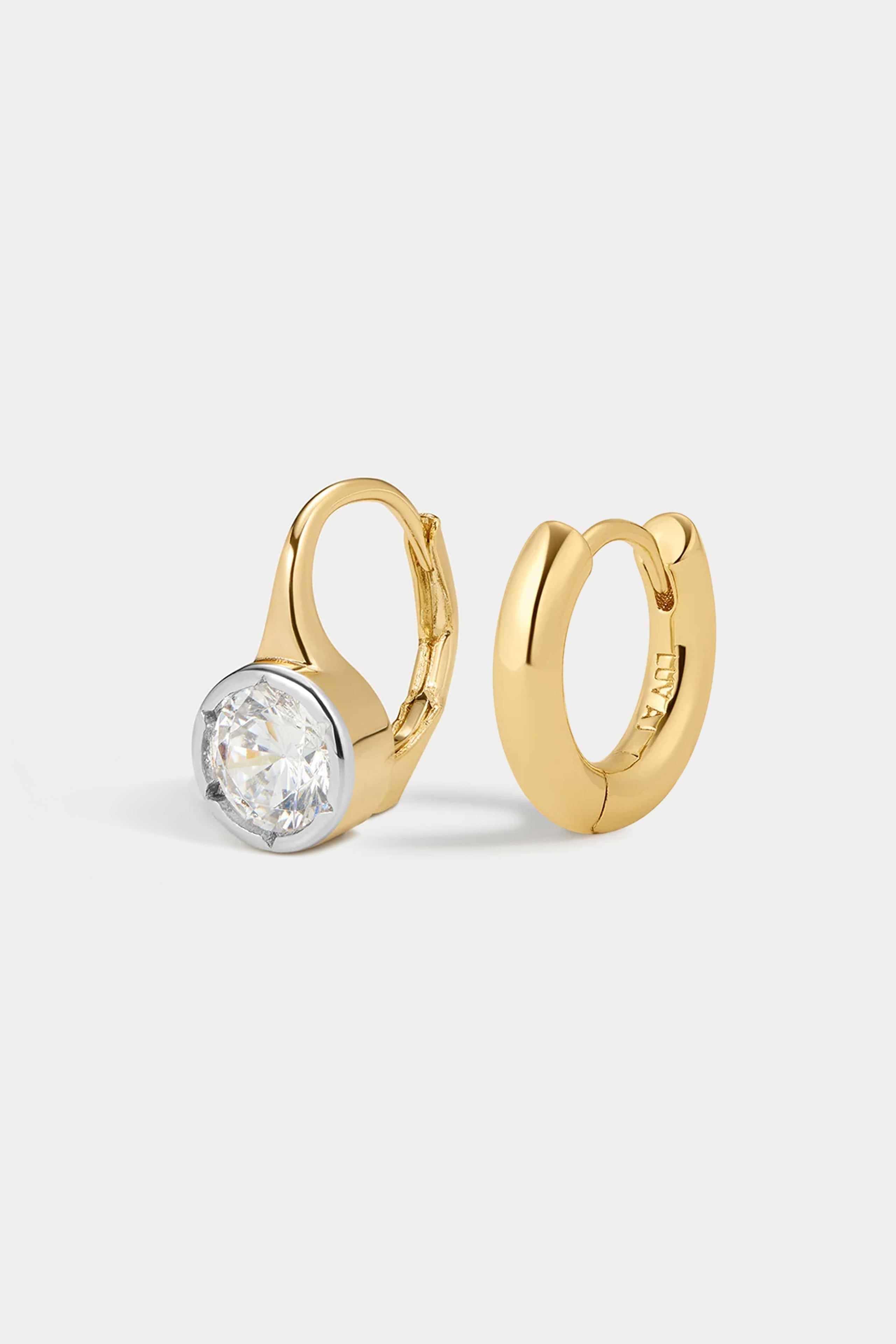The Melrose Set featuring a gold hoop earring with a single round-cut white stone in a bezel setting alongside a plain gold hoop earring.