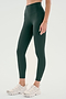 A person in SPLITS59’s Airweight High Waist Legging - Military, crafted from soft Airweight fabric, and white sneakers stands against a light background—ideal for hot yoga or everyday wear.