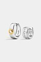 The Soho Set featuring two silver hoop earrings: one with a central gold-tone circle set with a round stone, and one with a row of channel-set square stones.