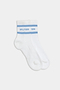 The SPLITS59 Logo Stripe Quarter Socks in White/Skylight feature a blue stripe and the brand's logo near the top, offering a classic retro athletic look.
