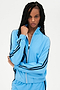 A woman wearing a SPLITS59 Fox Techflex Jacket in Cloudy Sky/Indigo, with black stripes, radiating a retro vibe.