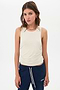 Young woman posing in a SPLITS59 Frida Jersey Tank in Vintage White designed for gym workouts and blue sweatpants.
