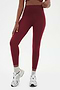 Front view of girl wearing highwasited dark red leggings with grey shoes