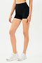 Half view of girl wearing black shorts and white shoes