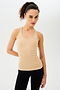 Front view of girl wearing a yellowish brown ribbed tank top and black leggings with white shoes
