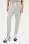 A woman wearing comfortable, SPLITS59 Kiki Rib 7/8 Sweatpant in Heather Grey and sneakers.