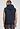 Back view of a men model wearing HA deep navy cotton Zippered vest