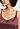 Close-up view of a women model wearing HA apple butter silk Spaghetti Top