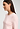 Close-up view of a women model wearing HA rosewater cotton L/SLV Shirt