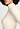 Close-up view of a women model wearing HA vanilla silk Turtle-Neck Shirt