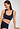 Close-up view of a women model wearing HA deep navy microfibre Crop Top