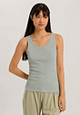 Front view of a women model wearing HA green tea cotton Tank Top