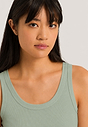 Close-up view of a women model wearing HA green tea cotton Tank Top