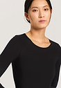 Close-up view of a women model wearing Hanro black cotton L/SLV Shirt