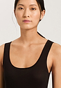 Close-up view of a women model wearing HA black cotton Tank Top