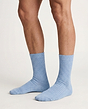 Front view of a women model wearing HA chalky blue wool Socks
