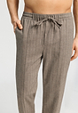 Close-up view of a men model wearing HA earthy woven cotton Long Pants