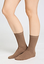Front view of a women model wearing HA canyon brown wool Socks