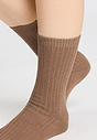 Back view of a women model wearing HA canyon brown wool Socks