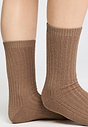 Close-up view of a women model wearing HA canyon brown wool Socks