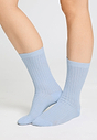 Front view of a women model wearing HA chalky blue wool Socks