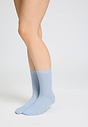 Back view of a women model wearing HA chalky blue wool Socks