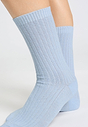 Close-up view of a women model wearing HA chalky blue wool Socks