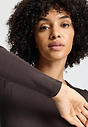 Close-up view of a women model wearing HA dark mocha cotton L/SLV Shirt