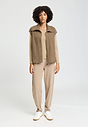 Full-body view of a women model wearing HA suede camel cotton Zippered vest