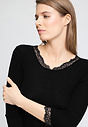 Close-up view of a women model wearing HA black wool 3/4 SLV Shirt
