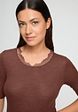 Close-up view of a women model wearing HA cinnamon wool S/SLV Shirt