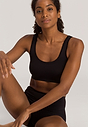 General view of a women model wearing Hanro black microfibre Crop Top